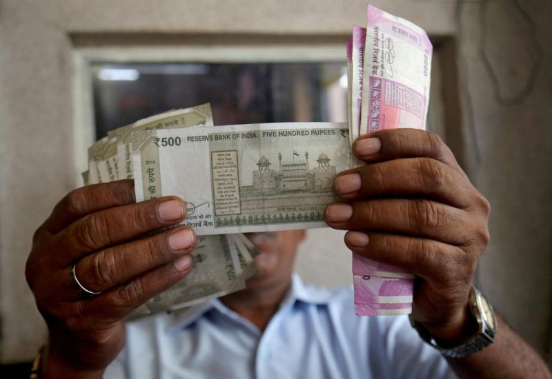 A cashier checks Indian rupee notes inside a room at a fuel station in Ahmedabad, India, September 20, 2018. REUTERS/Amit Dave